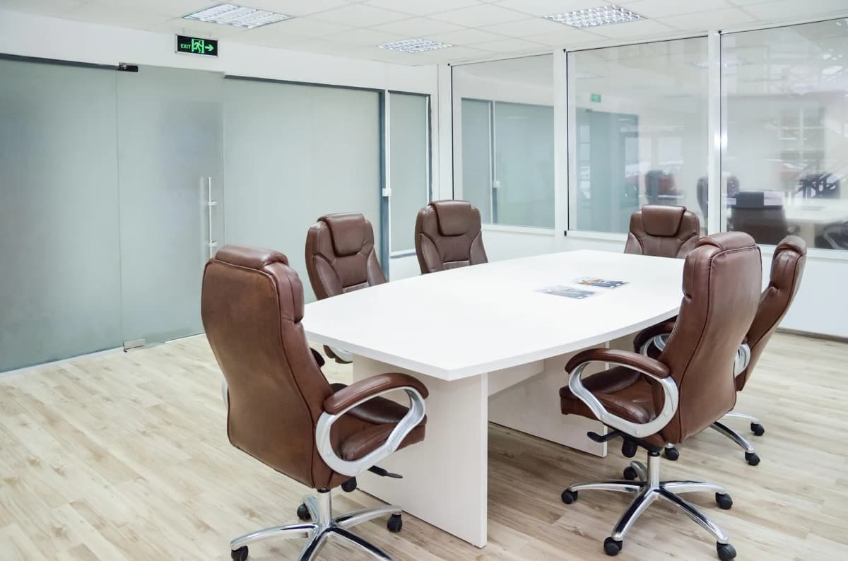 White Oval Conference Table with Leather Chairs